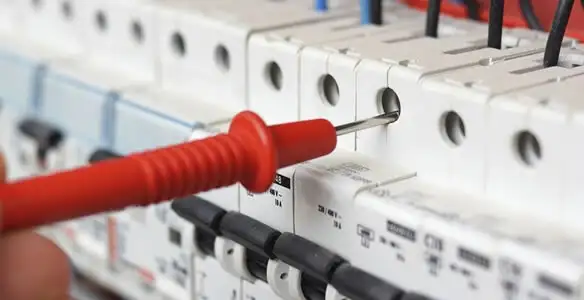 Electrical contractor testing circuit breakers during electrical repair in Hialeah, FL