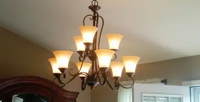 Classic ceiling chandelier installation with warm lighting in Miami, FL