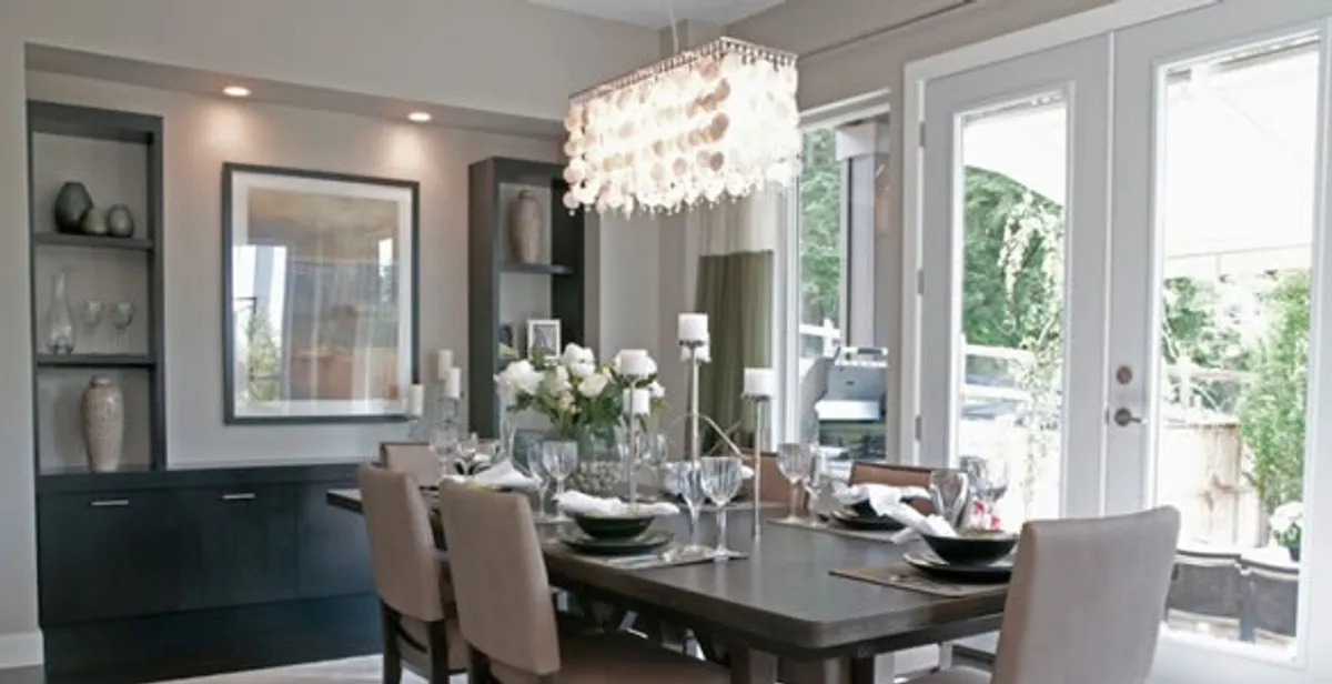 Elegant dining room chandelier installation above table in Miami, FL