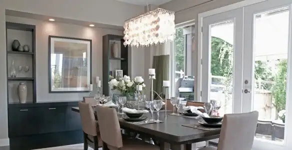 Elegant dining room chandelier installation above table in Miami, FL