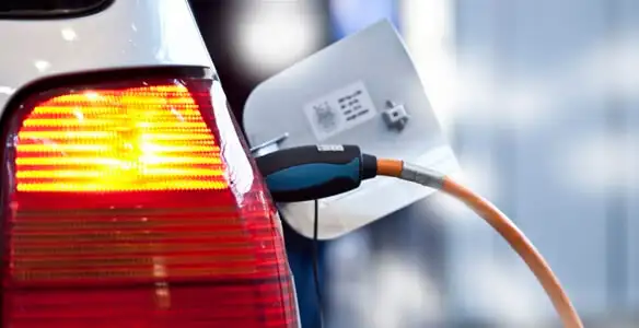 Electric car plugged into EV charger after professional installation in Miami, FL