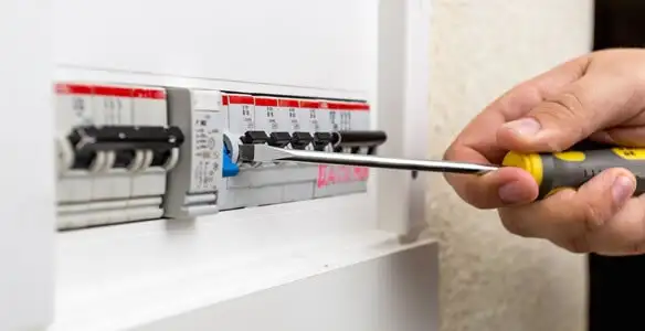 electrical panel upgrade service showing technician adjusting circuit breakers during system upgrade in Miami, FL