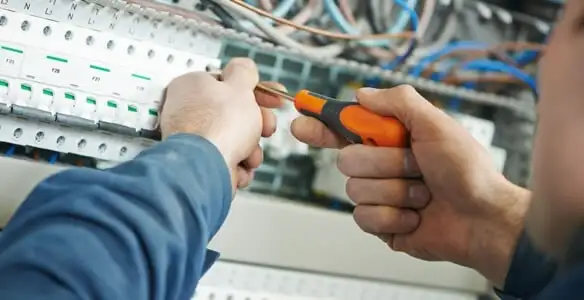 electrical service showing licensed electrician performing electrical panel maintenance and adjustments in Miami, FL