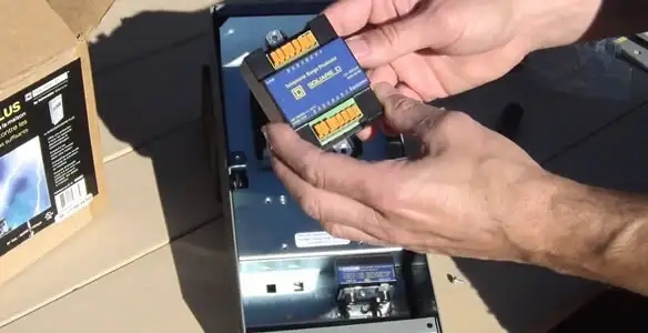 Electrician installing whole home surge protection unit inside main electrical panel in Miami, FL