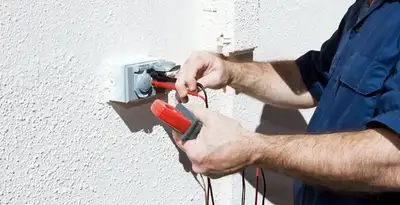 Electrician performing home electrical outlet and wiring inspection in Miami, FL