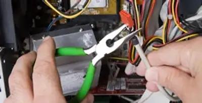 Licensed electrical contractor performing electrical repair with tools in Hollywood, FL