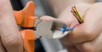 professional electrical services showing precise wire cutting by licensed electricians in Miami, FL