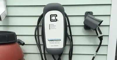 Outdoor electric vehicle charger installation on residential wall in Miami, FL