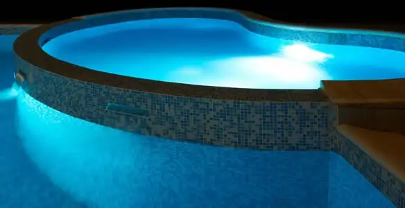 pool light installation and repair services highlighting illuminated pool interior lighting in Miami, FL