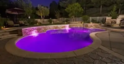 pool light installation and repair services illuminating a residential swimming pool in Miami, FL