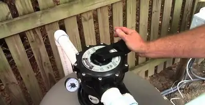 pool pumps service showing professional adjustment of pool pump control system in Miami, FL