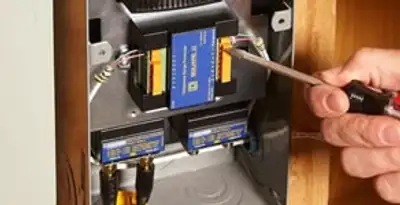 Whole home surge protection device being installed by a licensed electrician to protect electrical systems in Miami, FL